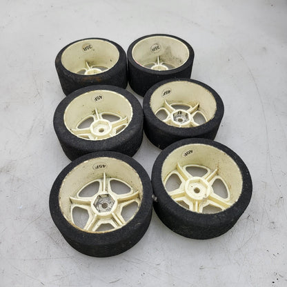 1/10th scale foam tires on cream colored 5 spoke wheels, x6 team associated?