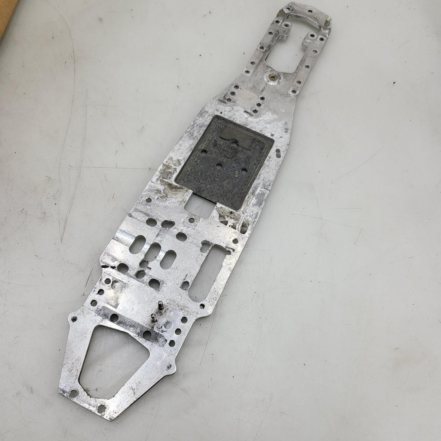Unknown nitro chassis with extra drilled holes, 15in long. Kyosho, Mugen ?