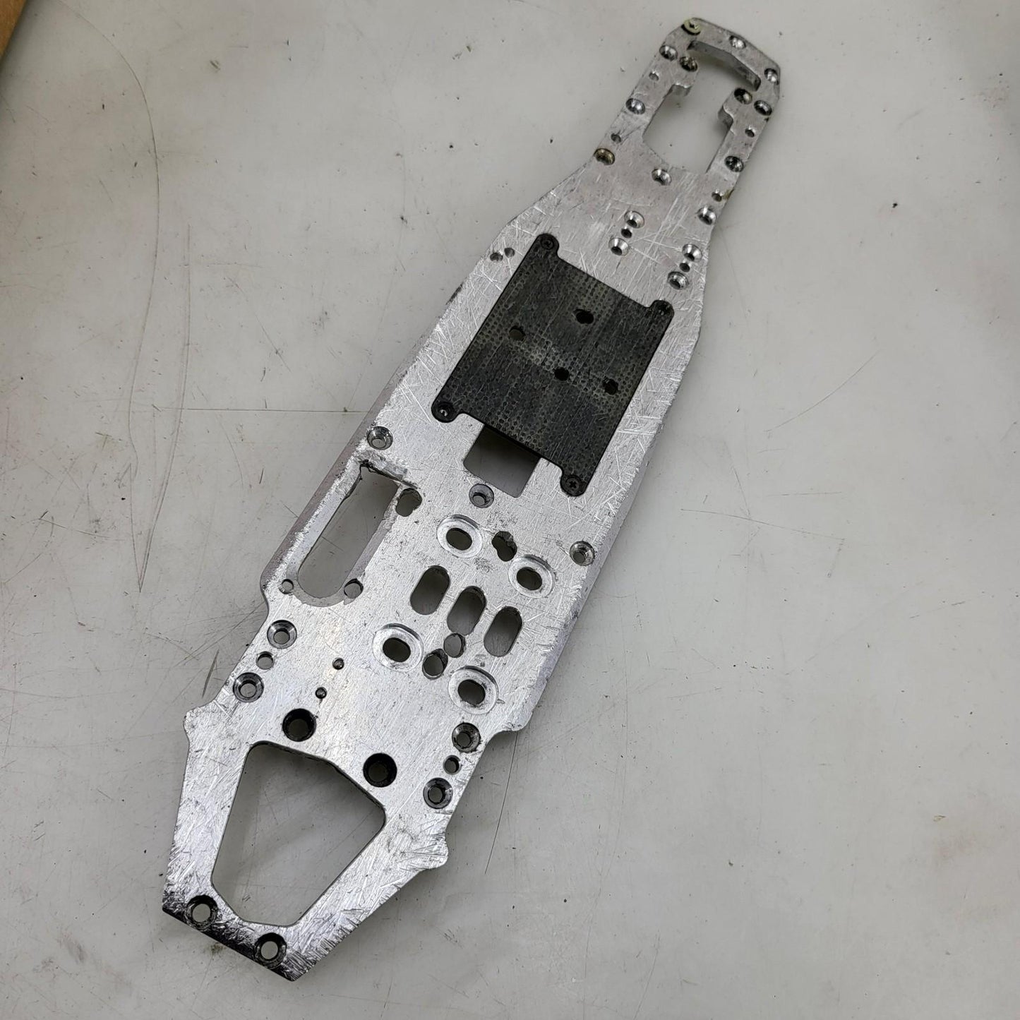 Unknown nitro chassis with extra drilled holes, 15in long. Kyosho, Mugen ?