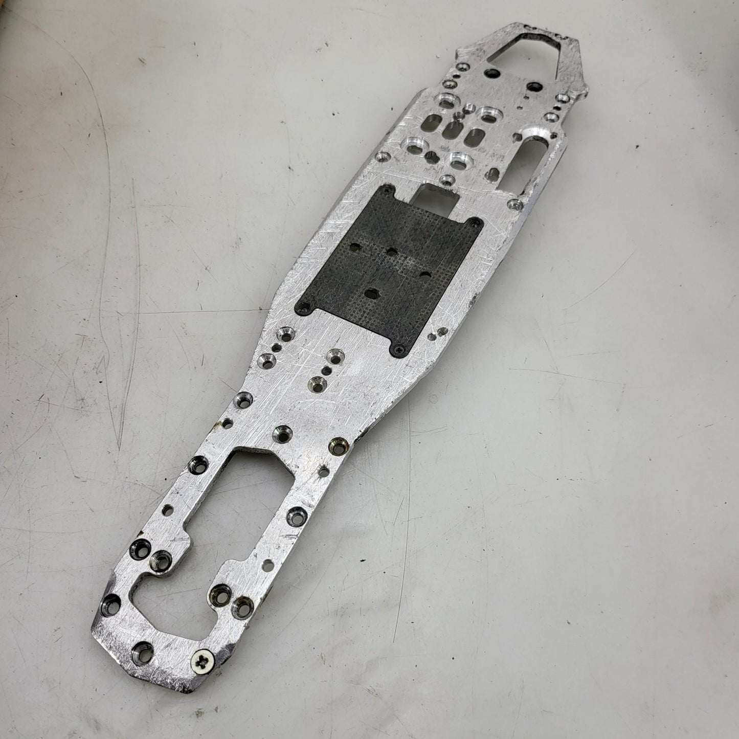 Unknown nitro chassis with extra drilled holes, 15in long. Kyosho, Mugen ?