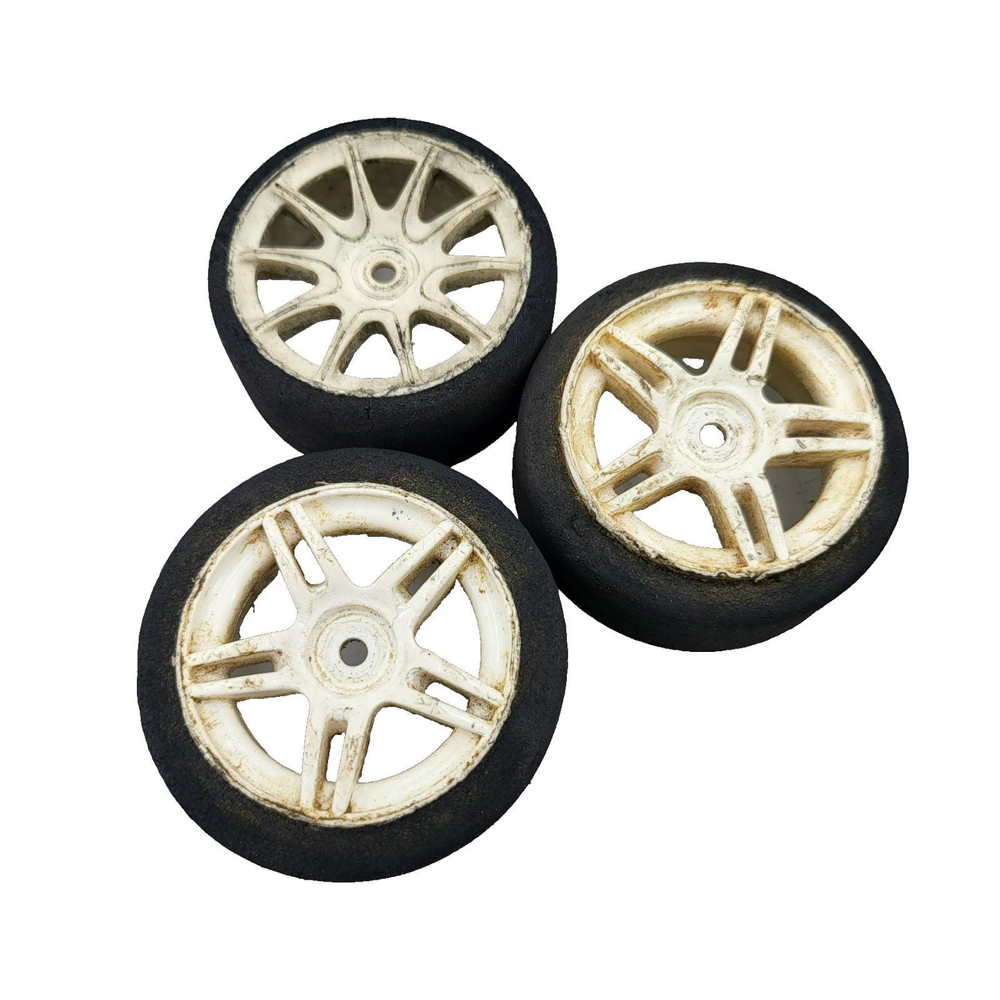 Team Associated Nitro TC3 foam tires on cream colored wheels x3, one different