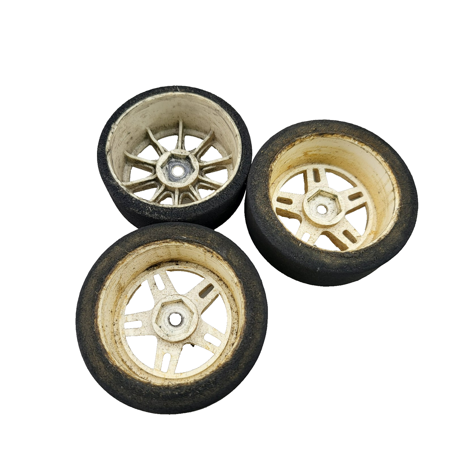 Team Associated Nitro TC3 foam tires on cream colored wheels x3, one different