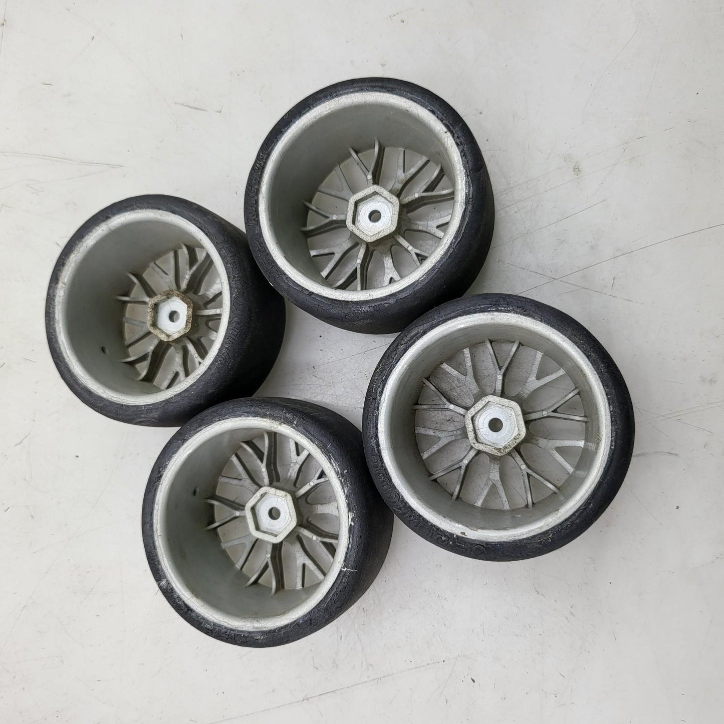 HPI Racing set of 4 1/10th tires with cracking on multi spoke light grey wheels