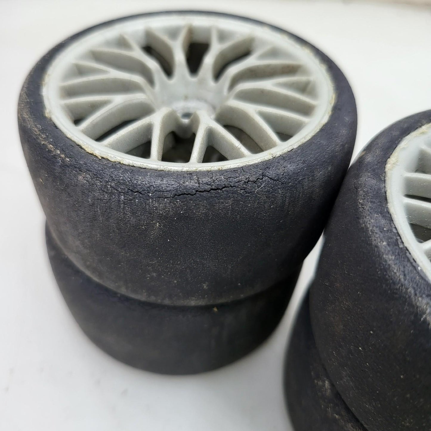 HPI Racing set of 4 1/10th tires with cracking on multi spoke light grey wheels