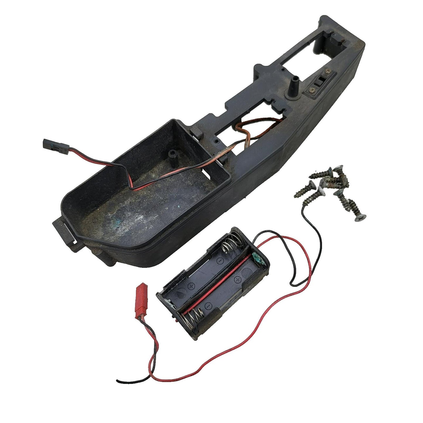 Duratrax Nitro Quake chassis composite deck with battery box, switch, wires cut.
