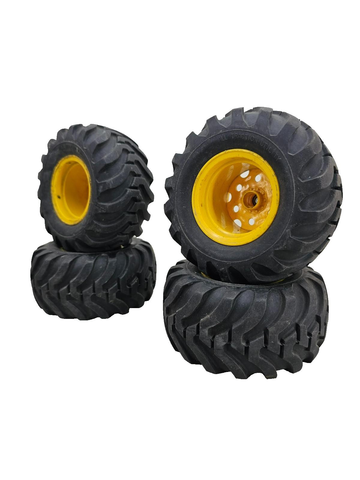Large All Traction Utility tires on yellow tractor type wheels, bearing style
