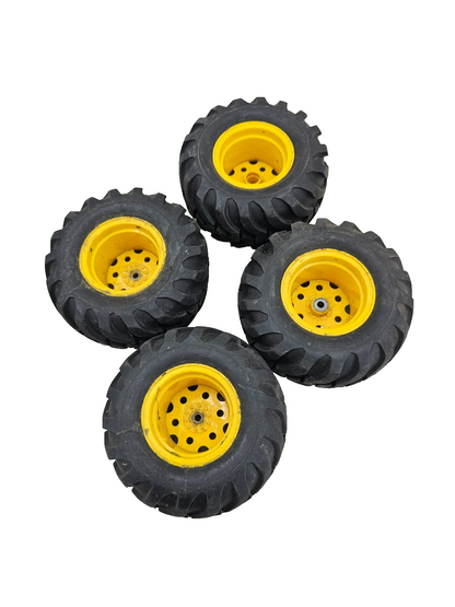 Large All Traction Utility tires on yellow tractor type wheels, bearing style