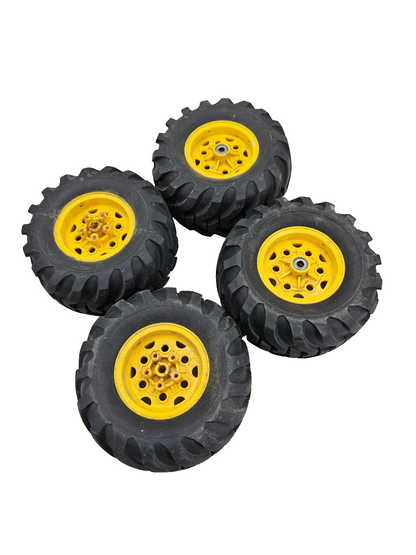 Large All Traction Utility tires on yellow tractor type wheels, bearing style